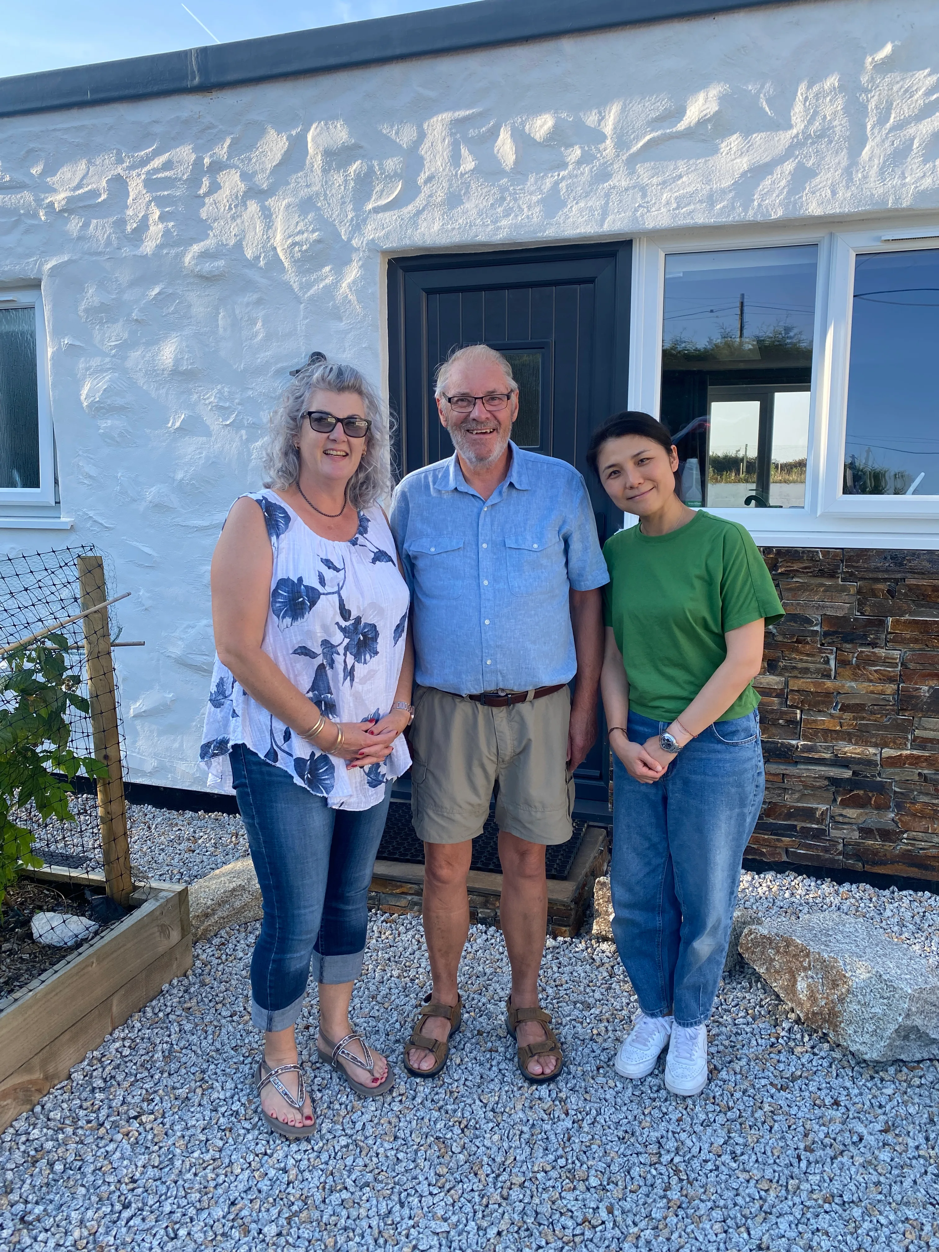 The Coppack family standing outside one of the cottages.