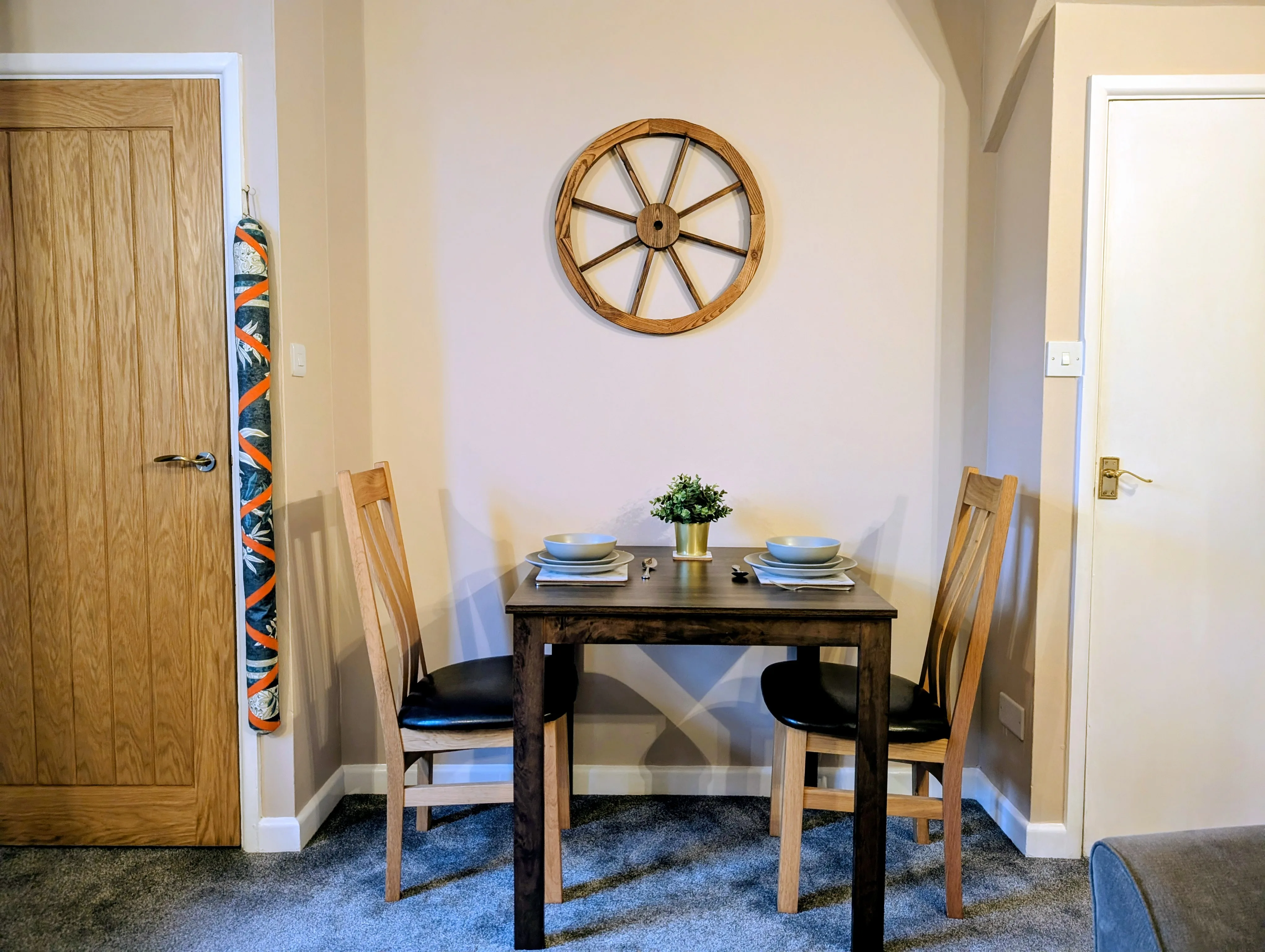 Little Avalon lounge with the dining area, sofa, log burner glowing.