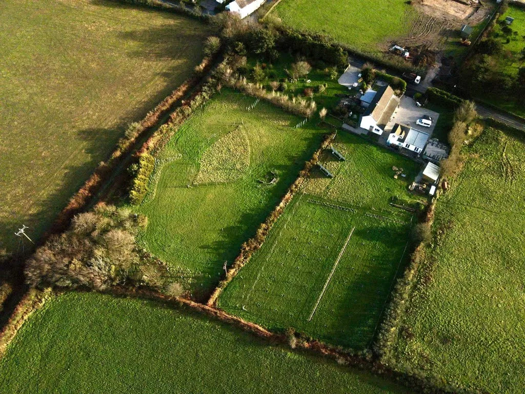 Aerial view of Trewena Cottages: three cottages, meadow and orchard, set in three acres on the edge of Falmouth.