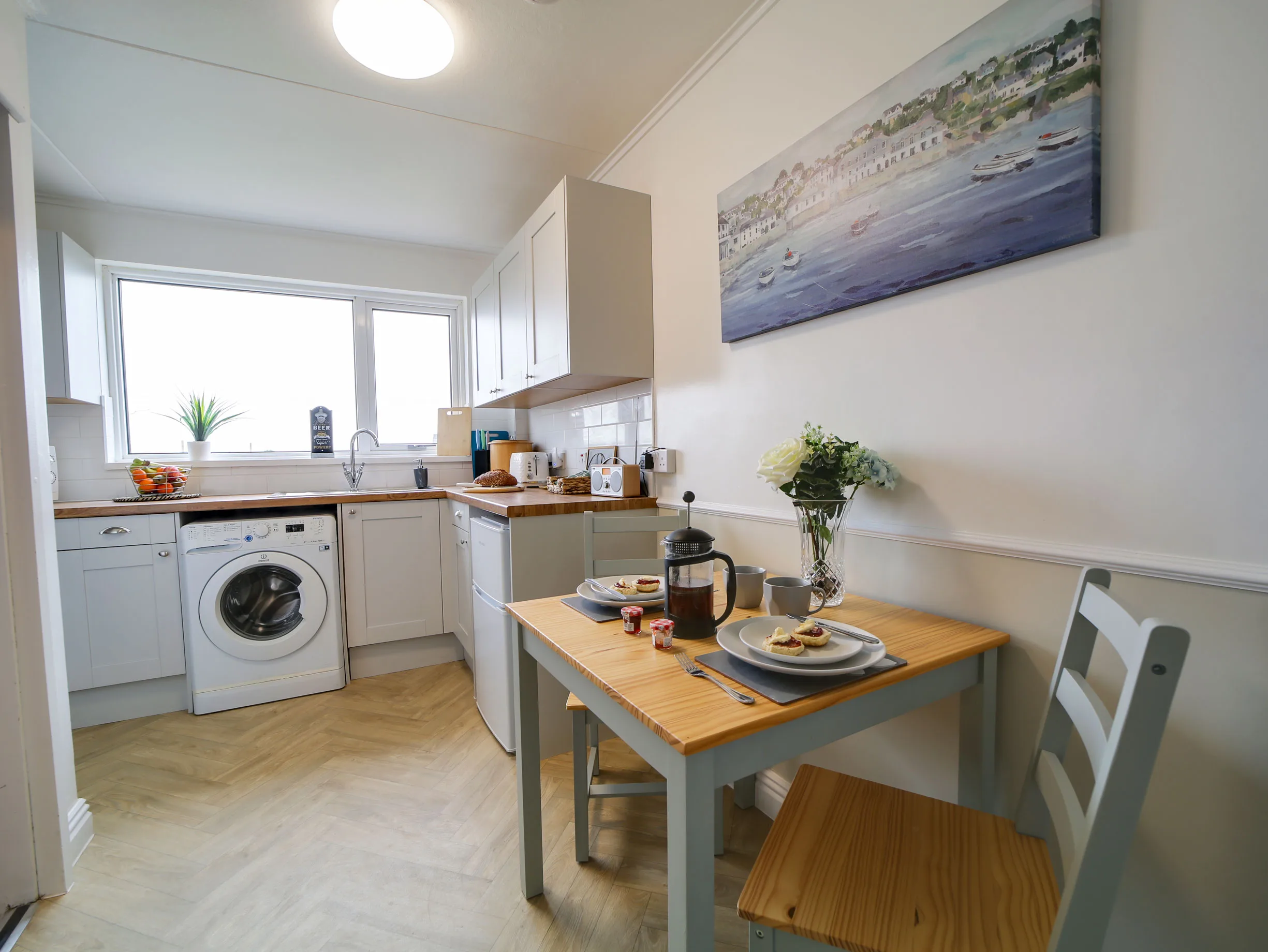 Little Avalon kitchen with dining table by the window.