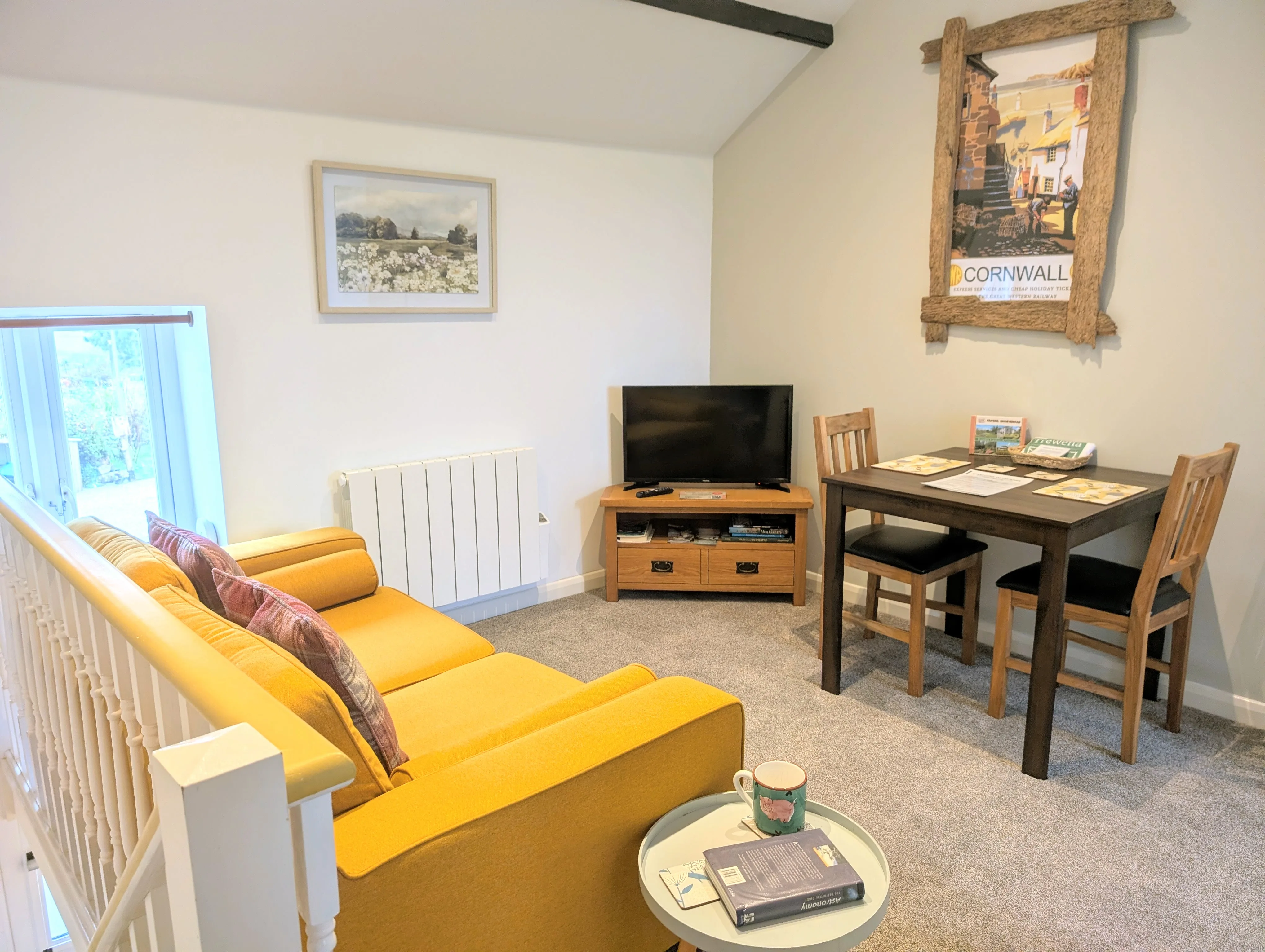The Pigsty's upstairs living area with high exposed beams.