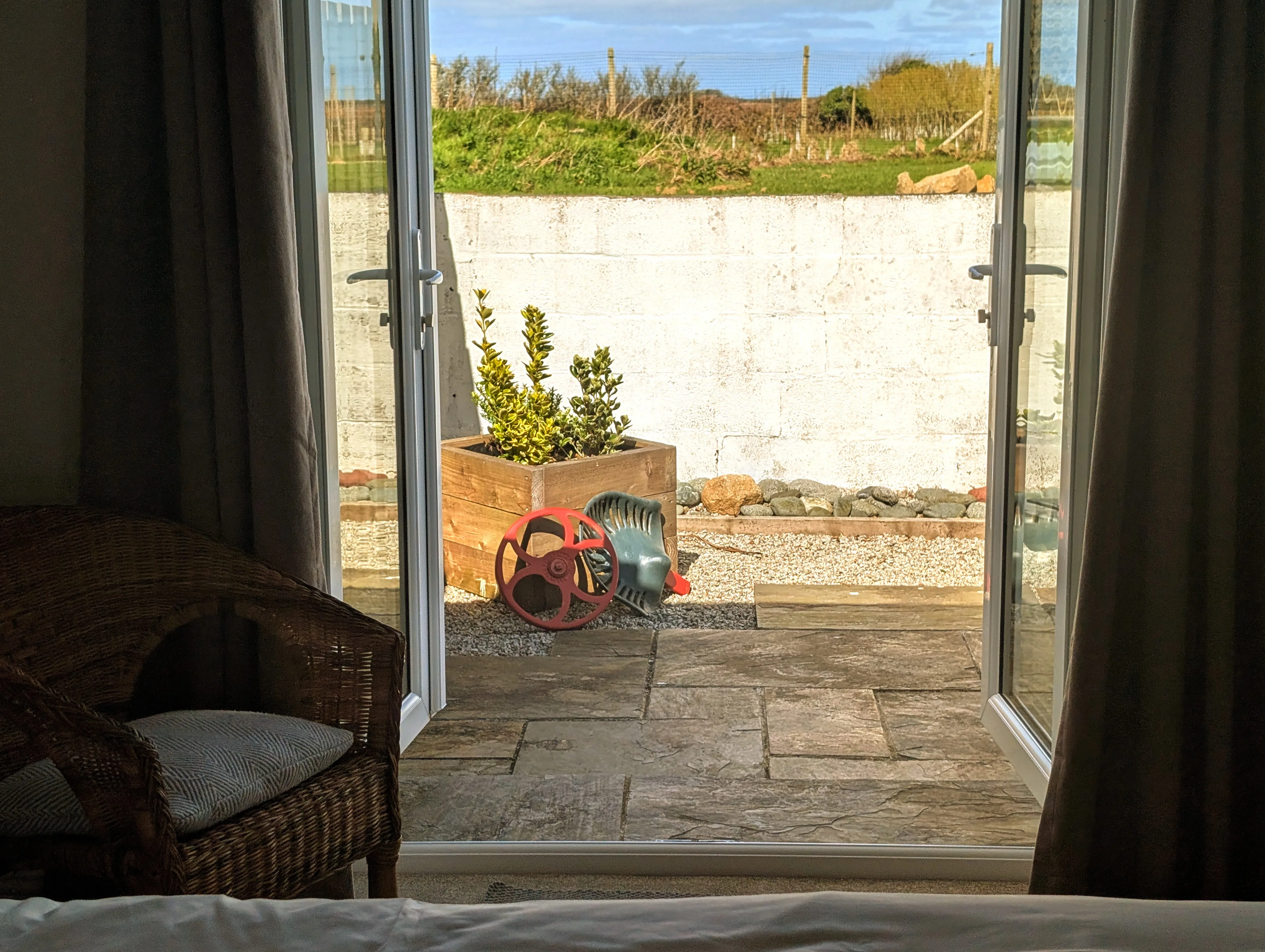 View from the Tractor Shed bedroom out through the French doors onto the patio.