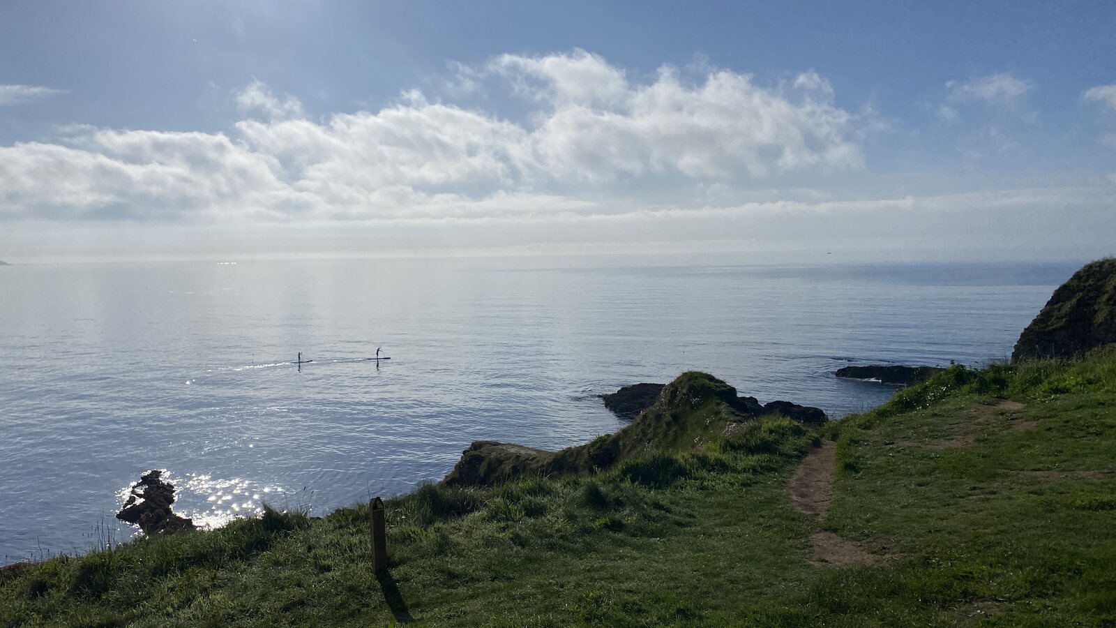 A coastal footpath leading towards Maenporth Beach with panoramic sea views, on the South West Coast Path near Falmouth.