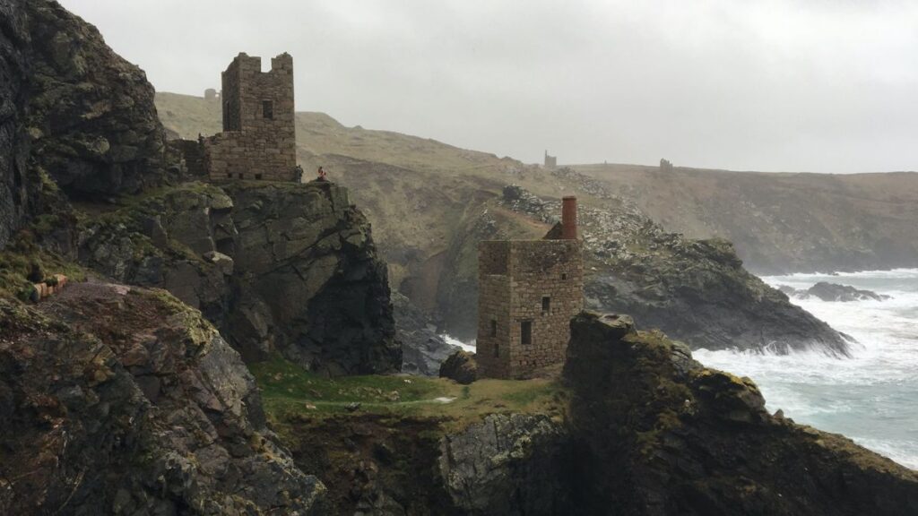 A dramatic view of Botallack Mine, with its historic engine houses perched on the rugged cliffs of Cornwall's wild Atlantic coast.