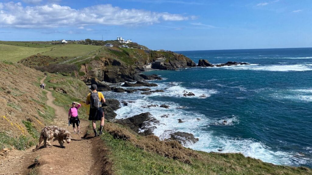A breathtaking view of Lizard Point, the southernmost tip of mainland Britain, with rugged cliffs and the Atlantic Ocean stretching to the horizon.