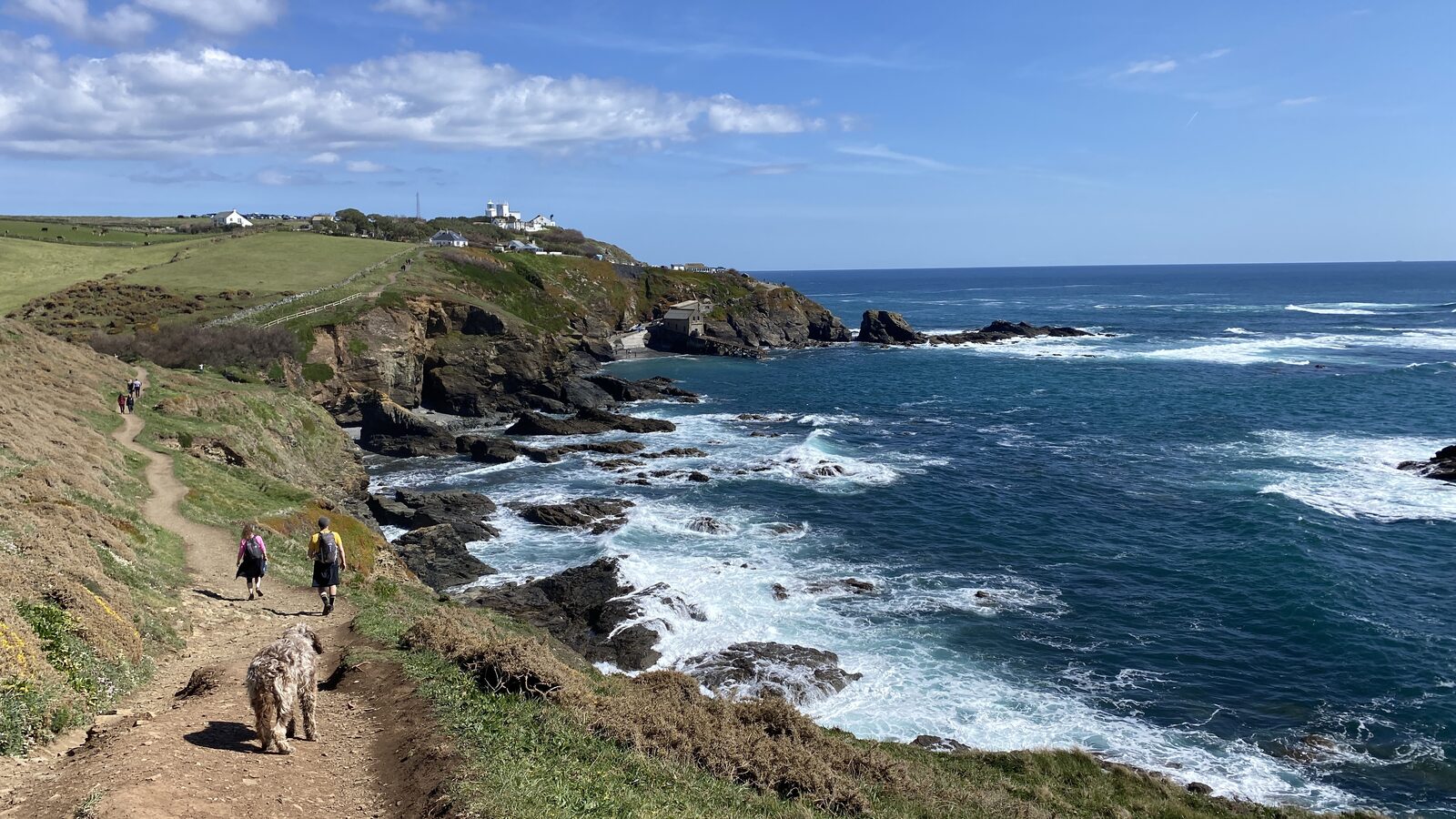 Lizard Point, the most southerly tip of mainland Britain, with the historic Lizard Lighthouse on the headland and the Atlantic stretching to the horizon.