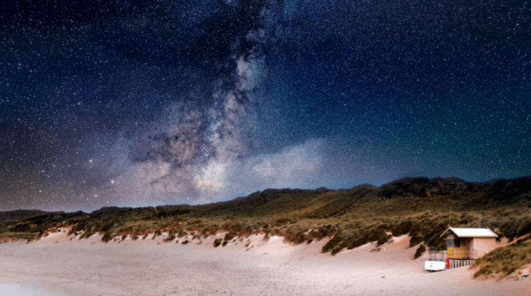 Stars and galaxies seen above a Cornish beach on a clear winter night